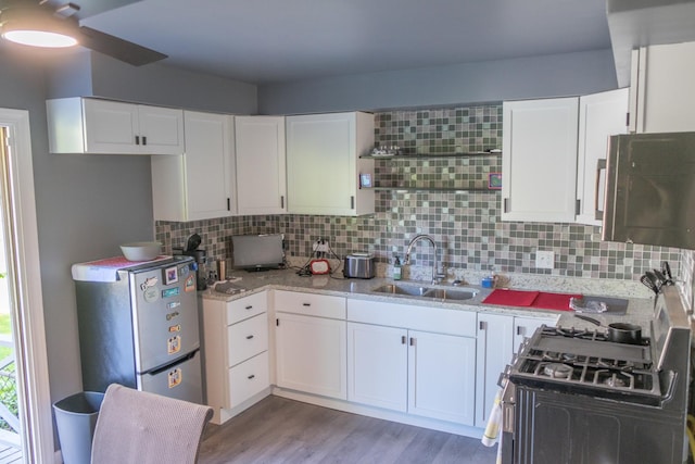 34 E 159th St, South Holland, IL 60473 - kitchen with a sink, range with gas cooktop, light wood-style flooring, decorative backsplash, and white cabinetry