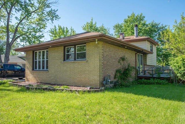 34 E 159th St, South Holland, IL 60473 - view of side of property featuring brick siding, a yard, and a deck