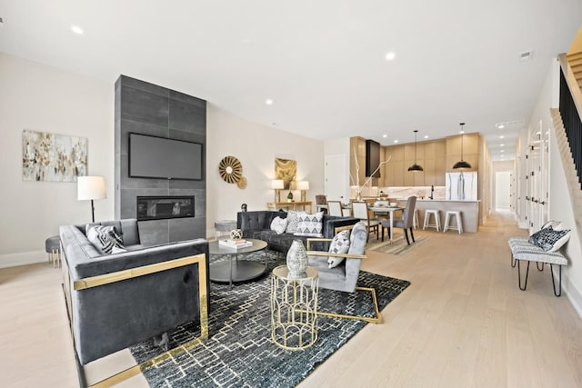 4343 N Richmond Ave Unit 3N, Chicago, IL 60618 - living room featuring light wood-type flooring, stairway, a large fireplace, recessed lighting, and baseboards