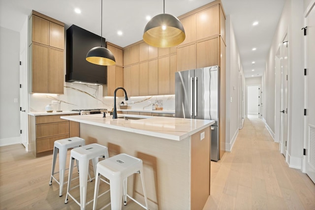 4343 N Richmond Ave Unit 3N, Chicago, IL 60618 - kitchen with freestanding refrigerator, a sink, premium range hood, light wood-type flooring, and an island with sink
