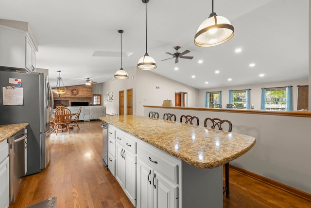 1527 62nd St, Downers Grove, IL 60516 - kitchen with ceiling fan, appliances with stainless steel finishes, wood finished floors, vaulted ceiling, and a kitchen bar