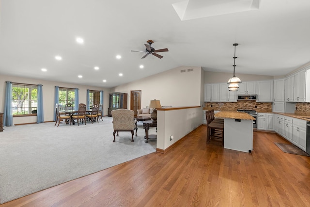 1527 62nd St, Downers Grove, IL 60516 - kitchen with stainless steel appliances, open floor plan, a breakfast bar, vaulted ceiling, and ceiling fan