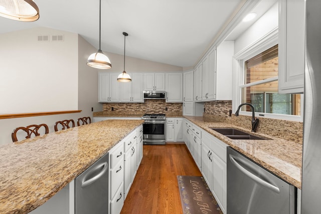 1527 62nd St, Downers Grove, IL 60516 - kitchen featuring stainless steel appliances, lofted ceiling, white cabinets, dark wood-style floors, and tasteful backsplash