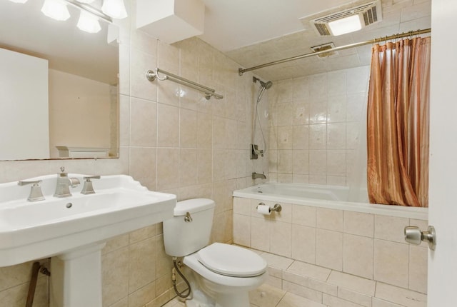 2236 Thornton Lansing Rd, Lansing, IL 60438 - full bathroom featuring tiled shower / bath combo, tile walls, toilet, a sink, and tile patterned floors