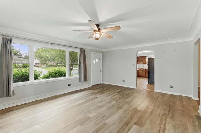 2236 Thornton Lansing Rd, Lansing, IL 60438 - spare room featuring arched walkways, ceiling fan, light wood-style flooring, baseboards, and ornamental molding