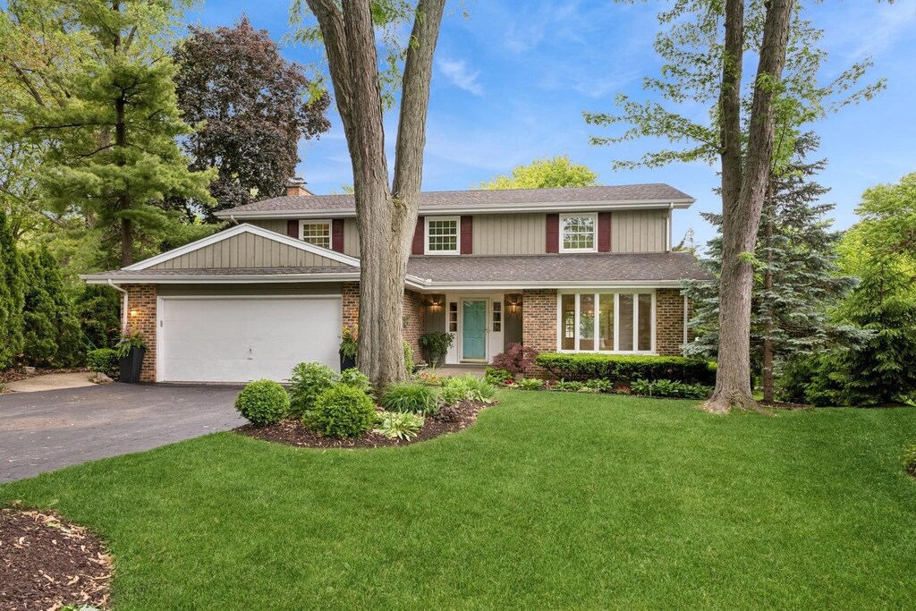 636 Concord Pl, Barrington, IL 60010 - traditional-style house with driveway, a garage, a front yard, and brick siding