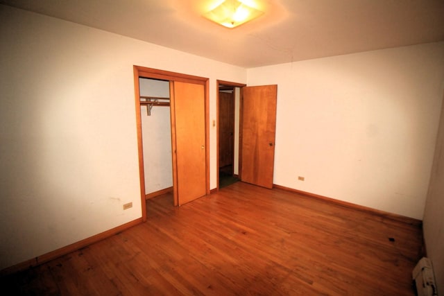 20340 Keeler Ave, Matteson, IL 60443 - unfurnished bedroom with a baseboard radiator, wood finished floors, baseboards, and a closet