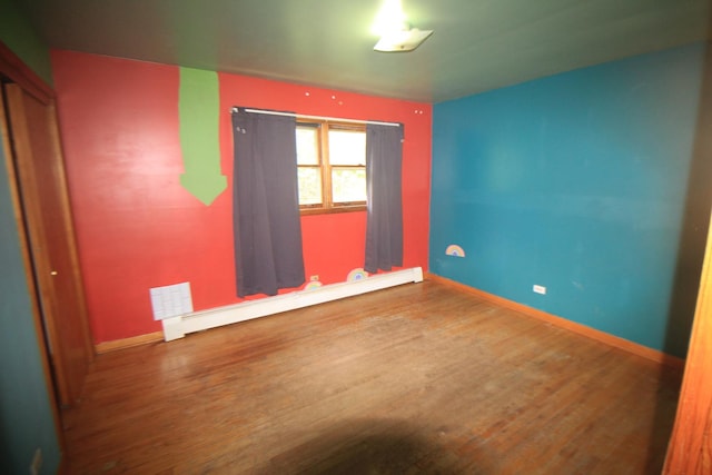 20340 Keeler Ave, Matteson, IL 60443 - spare room featuring wood finished floors, baseboards, and a baseboard radiator
