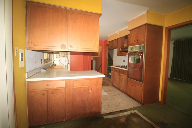 20340 Keeler Ave, Matteson, IL 60443 - kitchen with under cabinet range hood, light countertops, brown cabinets, gas cooktop, and light floors