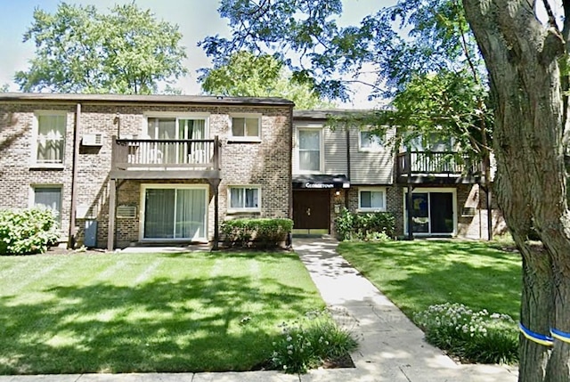 322 N Carter St Unit 102, Palatine, IL 60067 - townhome / multi-family property with a front lawn, a balcony, and brick siding