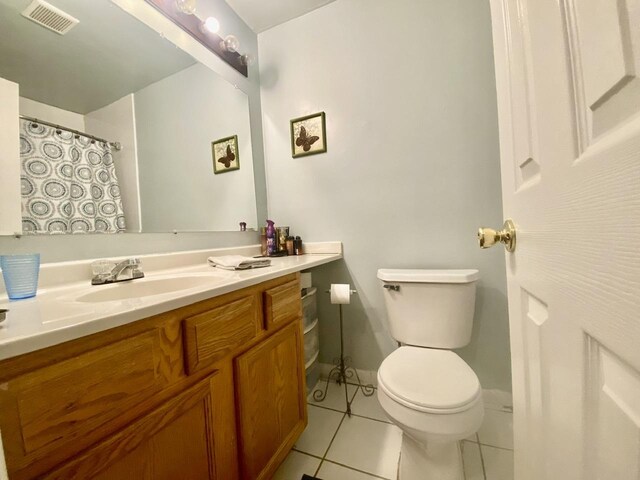 322 N Carter St Unit 102, Palatine, IL 60067 - full bathroom featuring toilet, vanity, tile patterned floors, and baseboards
