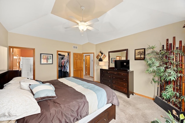 595 Sudbury Cir, Oswego, IL 60543 - bedroom with light colored carpet, ensuite bathroom, a walk in closet, a ceiling fan, and a closet