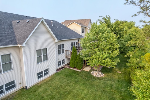 595 Sudbury Cir, Oswego, IL 60543 - back of property featuring a shingled roof, a yard, and a deck