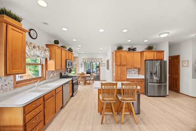 595 Sudbury Cir, Oswego, IL 60543 - kitchen featuring stainless steel appliances, backsplash, light wood-type flooring, and recessed lighting