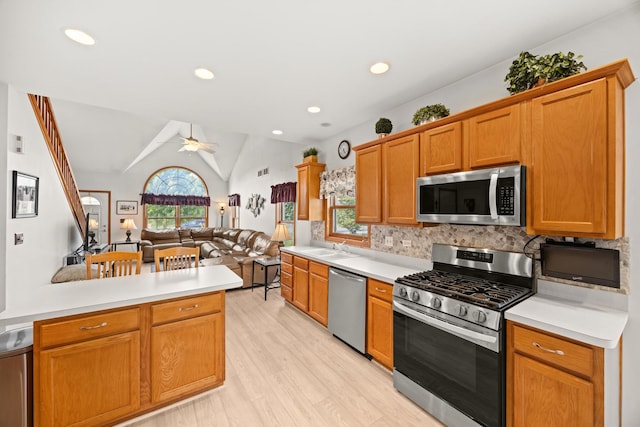 595 Sudbury Cir, Oswego, IL 60543 - kitchen with appliances with stainless steel finishes, open floor plan, a ceiling fan, light countertops, and lofted ceiling