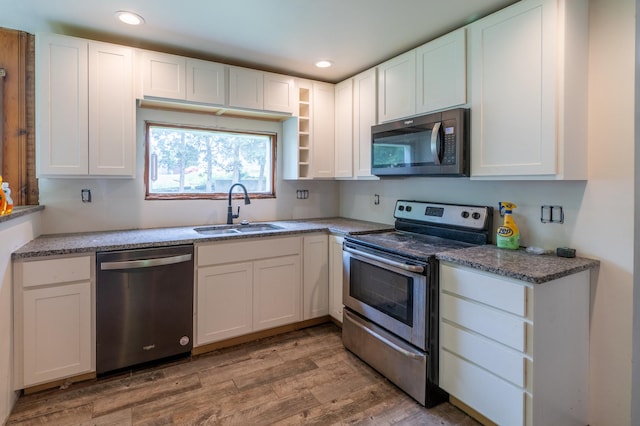 4 E Lincoln St, Mount Morris, IL 61054 - kitchen with appliances with stainless steel finishes, a sink, light wood-style floors, white cabinets, and recessed lighting
