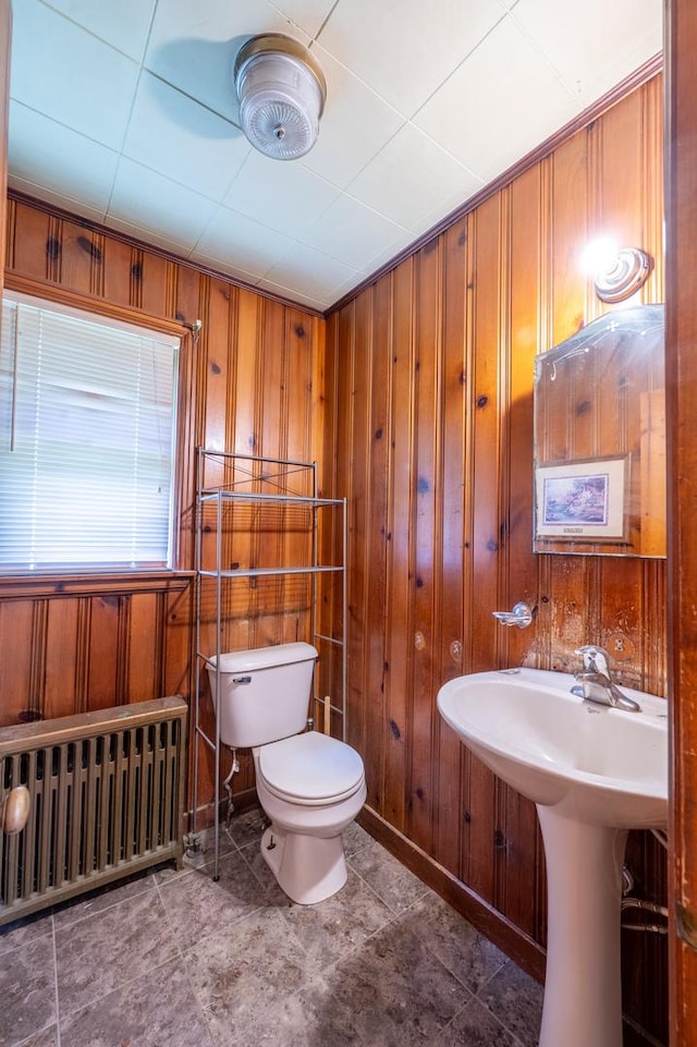 4 E Lincoln St, Mount Morris, IL 61054 - half bathroom featuring radiator heating unit, wooden walls, toilet, and baseboards