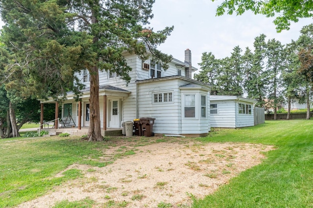 4 E Lincoln St, Mount Morris, IL 61054 - rear view of house with a chimney, a yard, and a porch