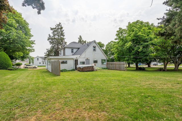 4 E Lincoln St, Mount Morris, IL 61054 - back of property with a lawn and a hot tub