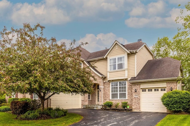 237 Colonial Dr, Vernon Hills, IL 60061 - view of front facade featuring asphalt driveway, brick siding, a garage, and a shingled roof