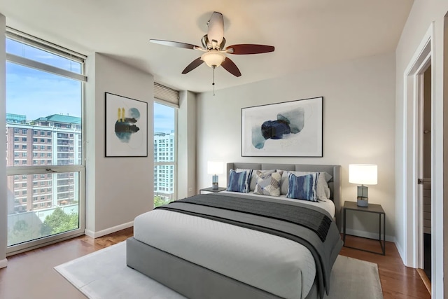 645 N Kingsbury St Unit 1203, Chicago, IL 60654 - bedroom with multiple windows, wood finished floors, and ceiling fan