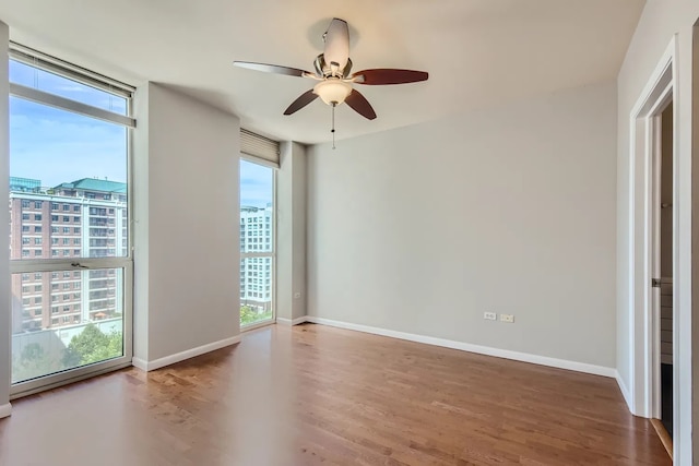 645 N Kingsbury St Unit 1203, Chicago, IL 60654 - unfurnished room featuring healthy amount of natural light, wood finished floors, a ceiling fan, and a city view