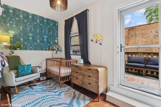 1956 W Bradley Pl Unit 2W, Chicago, IL 60613 - bedroom featuring wood finished floors, multiple windows, and wallpapered walls