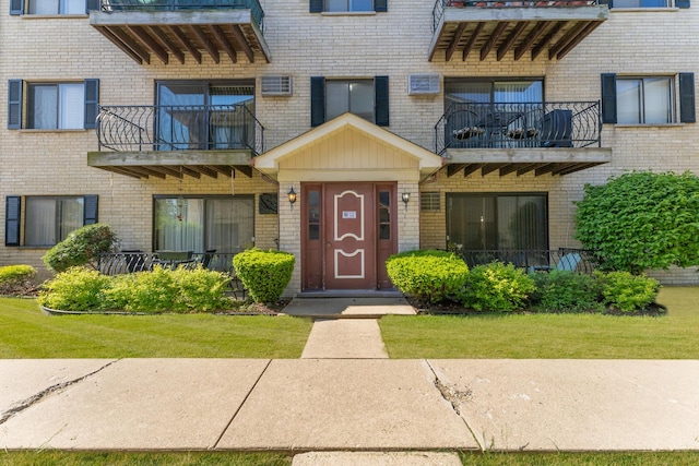 2155 N Harlem Ave Unit 205, Chicago, IL 60707 - doorway to property featuring a balcony, brick siding, and a yard