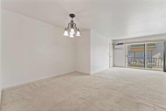 2155 N Harlem Ave Unit 205, Chicago, IL 60707 - carpeted empty room featuring a wall unit AC, baseboards, and a chandelier