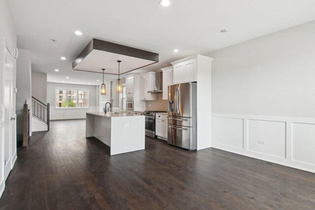 4637 S Michigan Ave, Chicago, IL 60653 - kitchen with stainless steel appliances, a sink, dark wood-style floors, an island with sink, and wall chimney range hood