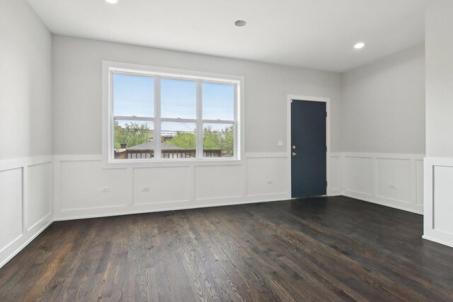 4637 S Michigan Ave, Chicago, IL 60653 - spare room with wainscoting, a decorative wall, and dark wood-style flooring