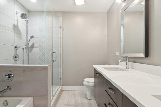 4637 S Michigan Ave, Chicago, IL 60653 - full bath featuring a shower stall, double vanity, toilet, a garden tub, and baseboards