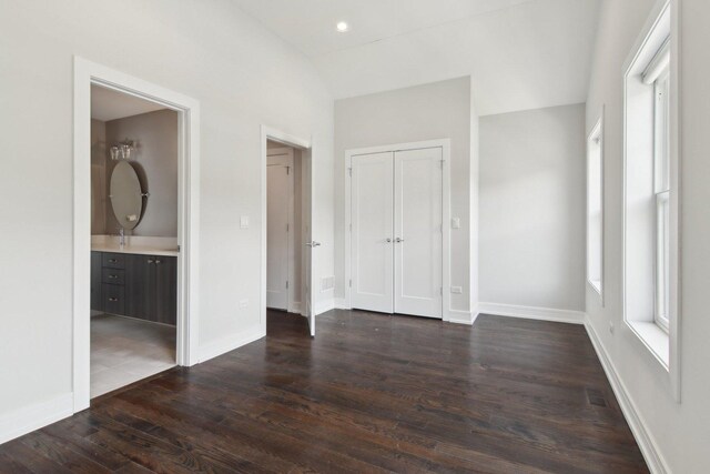 4637 S Michigan Ave, Chicago, IL 60653 - unfurnished bedroom with dark wood-style flooring, baseboards, a closet, and ensuite bathroom