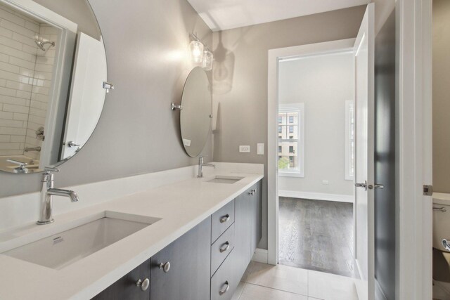 4637 S Michigan Ave, Chicago, IL 60653 - full bathroom with double vanity, toilet, baseboards, and tile patterned floors