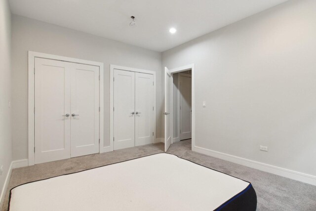 4637 S Michigan Ave, Chicago, IL 60653 - unfurnished bedroom featuring light carpet, baseboards, multiple closets, and recessed lighting