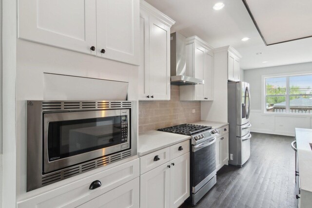 4637 S Michigan Ave, Chicago, IL 60653 - kitchen with stainless steel appliances, wall chimney exhaust hood, light countertops, white cabinets, and tasteful backsplash