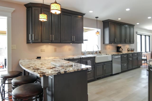 6421 157th St W, Oak Forest, IL 60452 - kitchen with a sink, dishwasher, light stone countertops, a peninsula, and a breakfast bar area