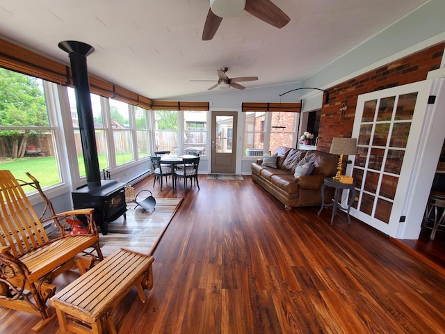 6421 157th St W, Oak Forest, IL 60452 - sunroom featuring a wood stove, healthy amount of natural light, vaulted ceiling, wood finished floors, and a wooden deck