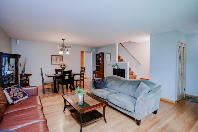 612 S Blvd Unit C, Evanston, IL 60202 - living room with a chandelier, stairway, and light wood-style floors