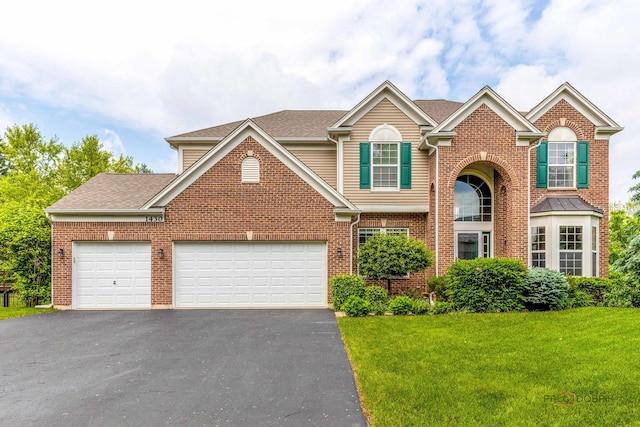 1430 Mcclellan Ct, Lindenhurst, IL 60046 - traditional-style home featuring asphalt driveway, a front yard, a garage, and brick siding