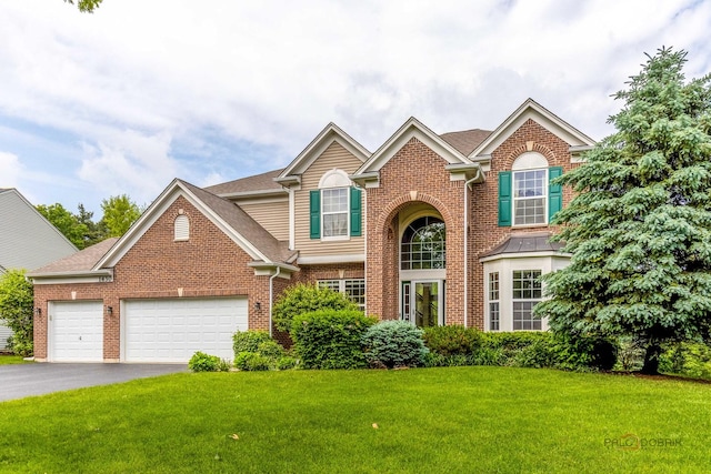 1430 Mcclellan Ct, Lindenhurst, IL 60046 - traditional-style house with an attached garage, brick siding, a front yard, driveway, and roof with shingles