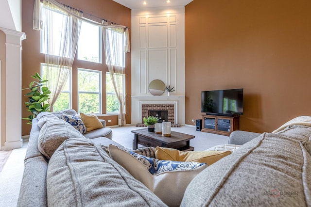 1430 Mcclellan Ct, Lindenhurst, IL 60046 - carpeted living area with a towering ceiling, ornate columns, baseboards, and a tile fireplace