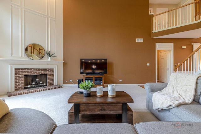 1430 Mcclellan Ct, Lindenhurst, IL 60046 - carpeted living area with a towering ceiling, stairway, baseboards, and a brick fireplace