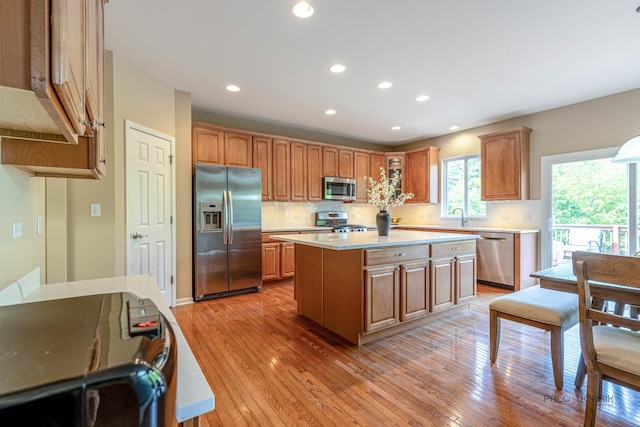 1430 Mcclellan Ct, Lindenhurst, IL 60046 - kitchen with appliances with stainless steel finishes, light countertops, a kitchen island, recessed lighting, and tasteful backsplash