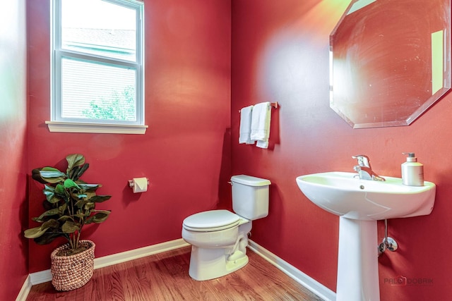 1430 Mcclellan Ct, Lindenhurst, IL 60046 - half bathroom featuring toilet, wood finished floors, and baseboards