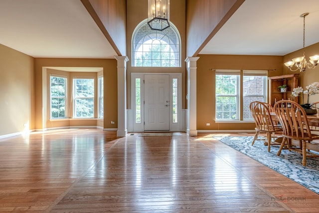 1430 Mcclellan Ct, Lindenhurst, IL 60046 - foyer entrance with decorative columns, a chandelier, plenty of natural light, and wood-type flooring