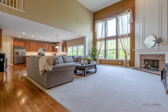 1430 Mcclellan Ct, Lindenhurst, IL 60046 - living area with a towering ceiling, recessed lighting, a brick fireplace, light wood-style floors, and baseboards