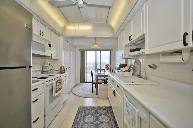 4901 Golf Rd Unit 310, Skokie, IL 60077 - kitchen featuring white appliances, ceiling fan, light tile patterned floors, and white cabinets