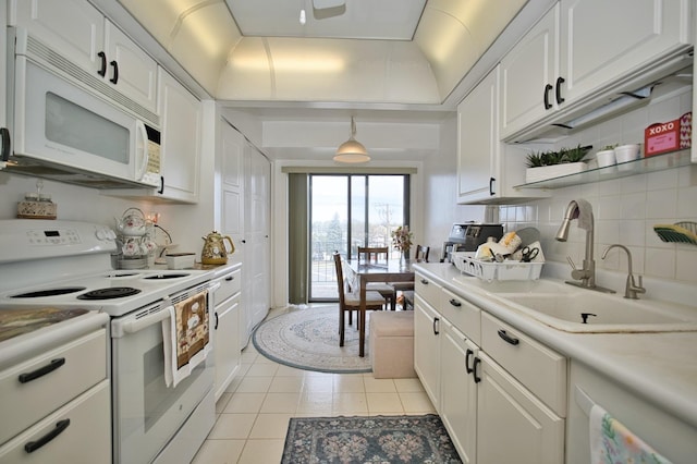 4901 Golf Rd Unit 310, Skokie, IL 60077 - kitchen featuring white appliances, a sink, white cabinetry, light tile patterned floors, and tasteful backsplash