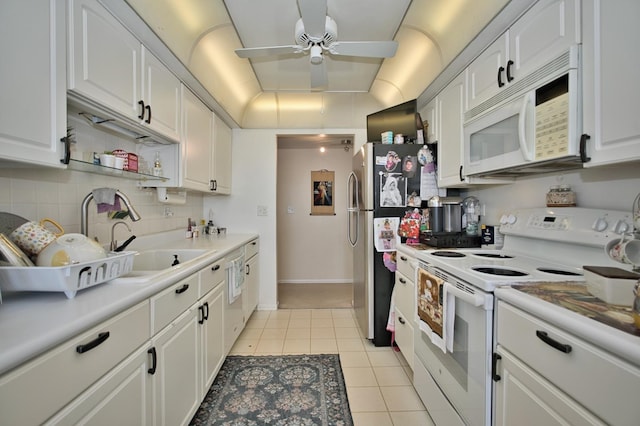 4901 Golf Rd Unit 310, Skokie, IL 60077 - kitchen featuring white appliances, a sink, white cabinetry, light tile patterned flooring, and a ceiling fan